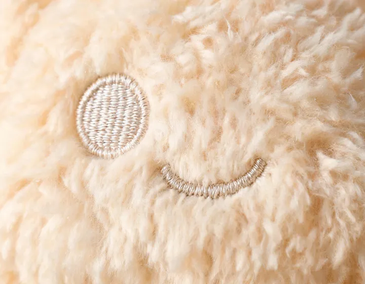 Embroidered plush toy face close up